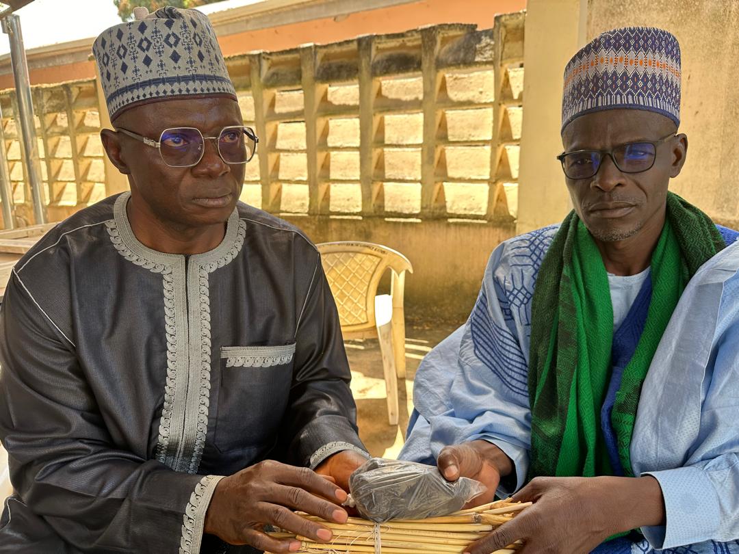 Pastor Baru (l) donating the materials to an Islamic cleric